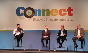 During a panel session at the recent EFI Connect conference, Hardwire CEO George Tunis (second from right) and EFI's Frank Mallozzi (far left) discuss a bulletproof Hardwire clipboard that features graphics  printed on Tunis's new EFI VUTEk QS2 Pro UV-inkjet printer.