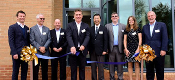Photograph shows Jerry Davies (Managing Director, Roland DG (UK) Ltd) cutting the ribbon to mark the official opening of Roland DG UK’s new head office and Creative Centre. Overseen by Mr Tomioka, President of Roland DG Corporation and members of the Roland DG senior management team, both in the UK and internationally